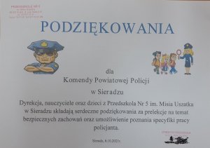 Plakat z logo policji z odciskami rączek dzieci oraz imionami